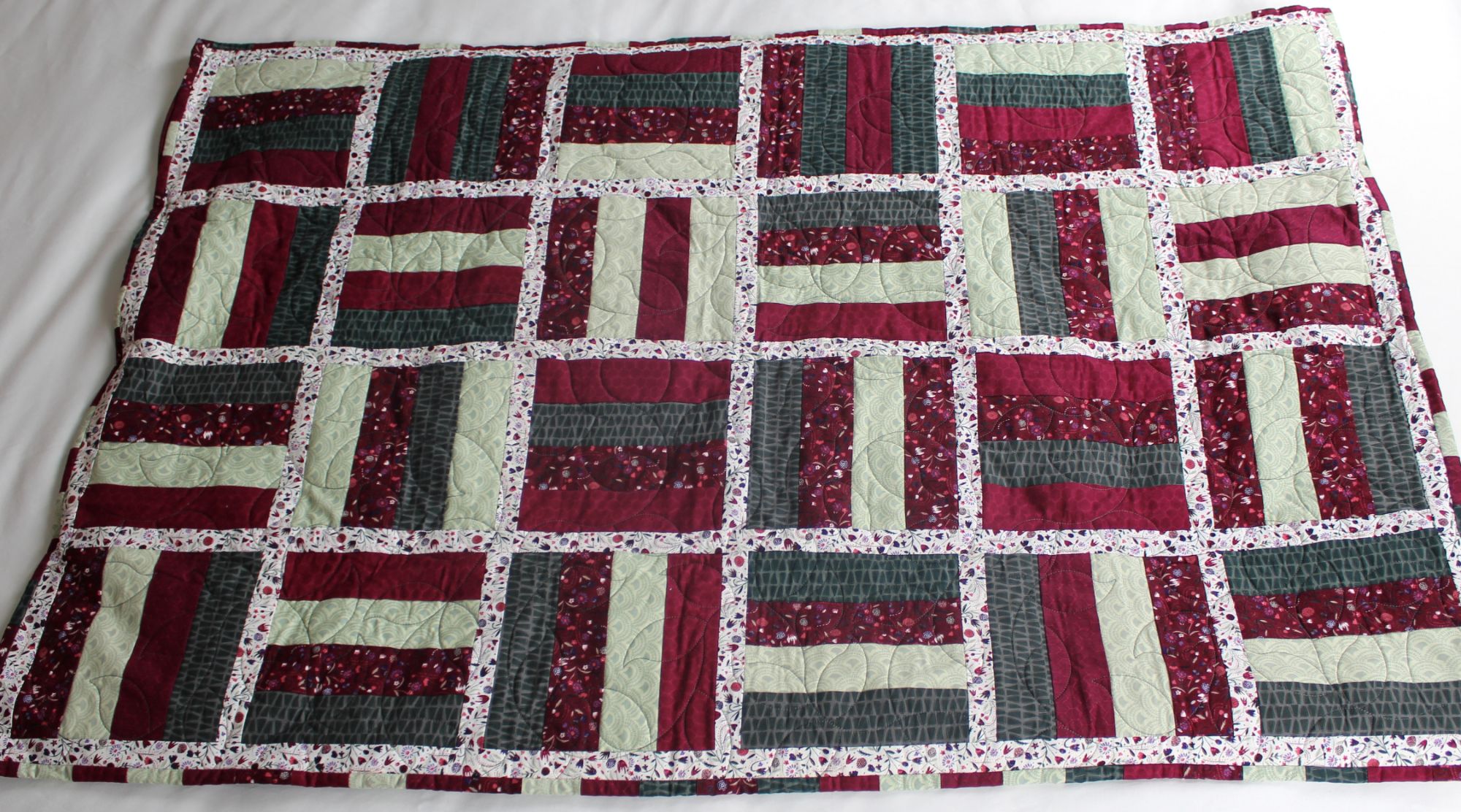 Midtown and Mayfair handmade lavender weighted quilt, rail fence patchwork in burgundy, sage, and slate green with floral sashing