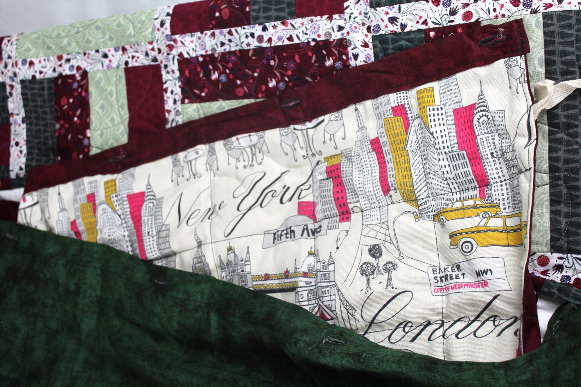 Close-up of the New York and London cityscape print covering the removable lavender-filled insert of the Midtown and Mayfair quilt